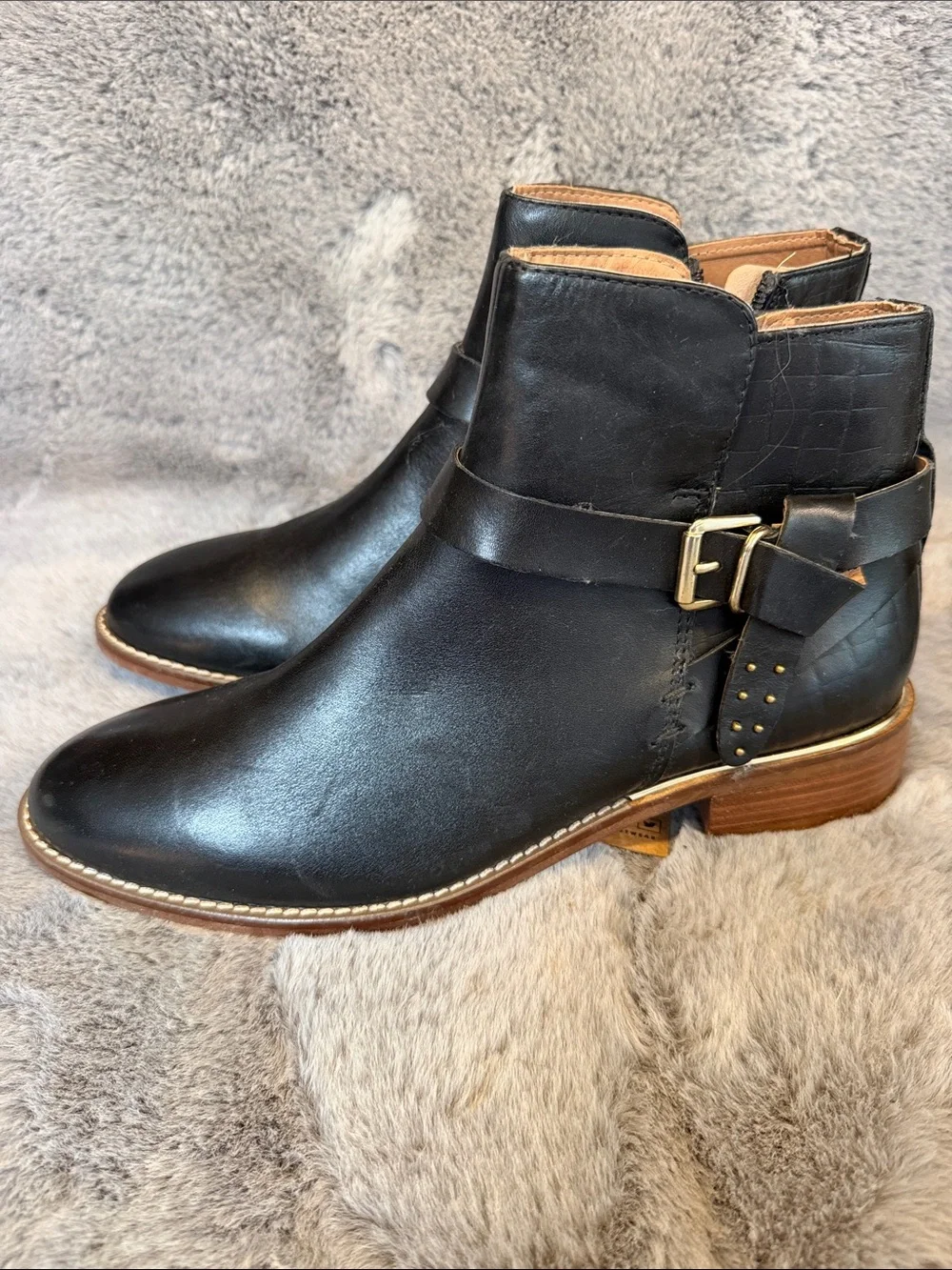 Black leather ankle boots with gold trim